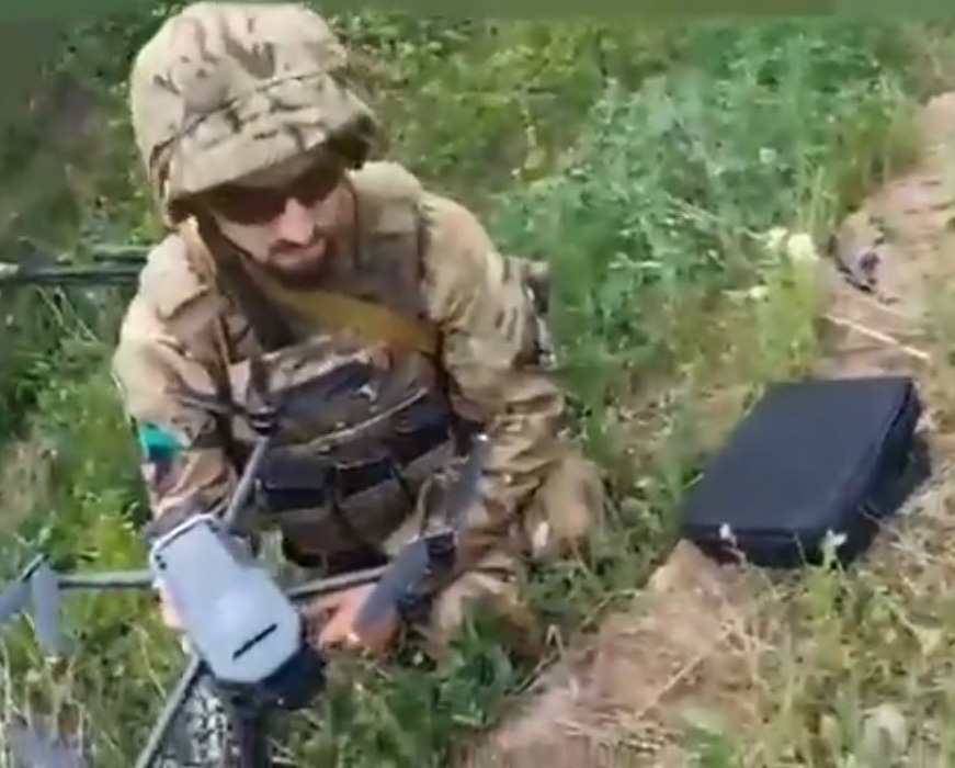 A Ukrainian fighter handling the drone used to bomb out Russian positions