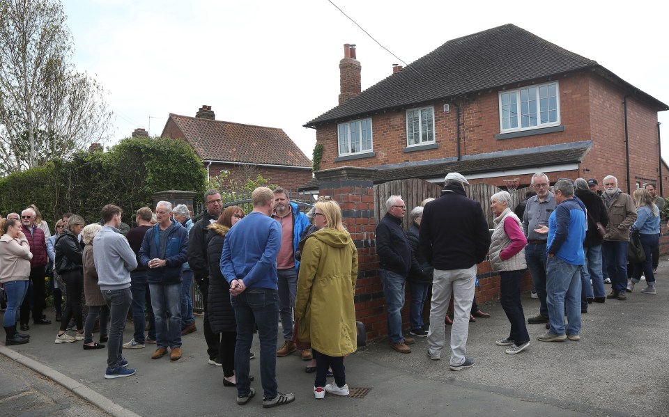 Worried villagers queue for a meeting last month to discuss the plan for a 1,500-capacity asylum centre