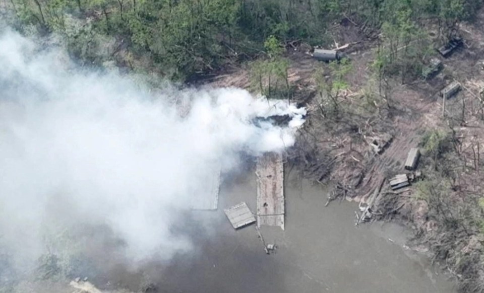 Smoke rises from what appears to be a makeshift bridge bombed by Ukrainian troops