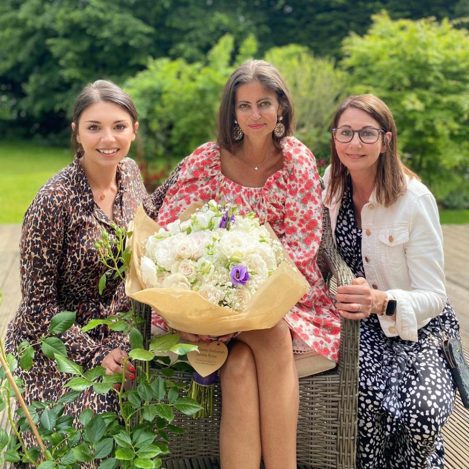 Dame Deborah posing with her special bouquet of flowers named after her