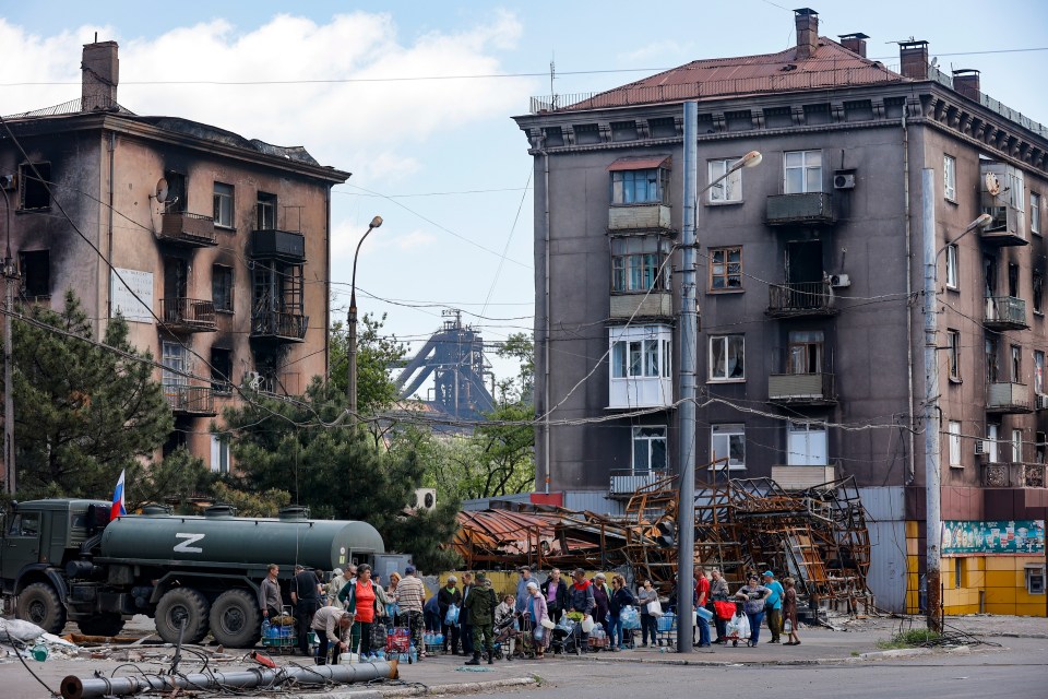 Occupying Russian troops distribute water to civilians in devastated Mariupol