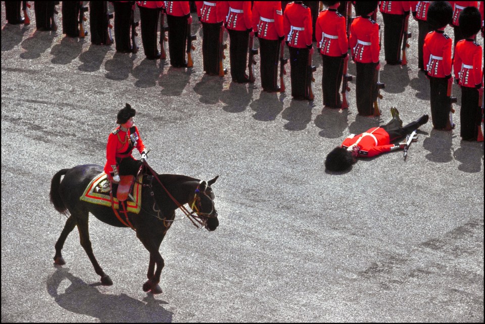 The Queen rides her beloved horse Burmese past a guardsman who had fainted in 1970