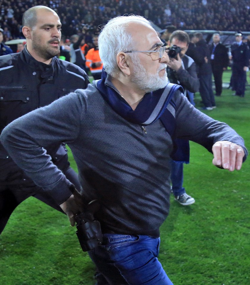 PAOK owner Ivan Savvidis reaches for his gun on the pitch at the end of a game against AEK Athens