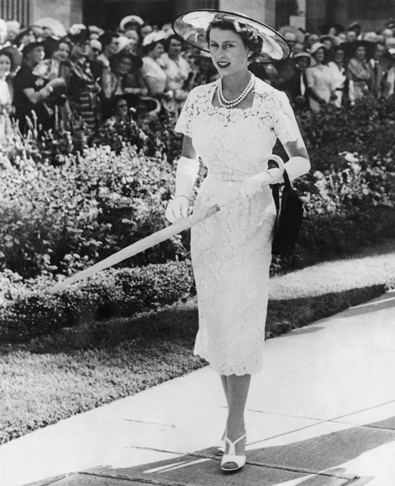 The Queen in a slim-fitting lace dress as she attends a Syndey garden party in 1954