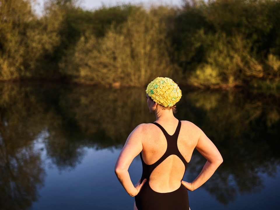 A wild swimmer in Essex prepares for a dip in a lake