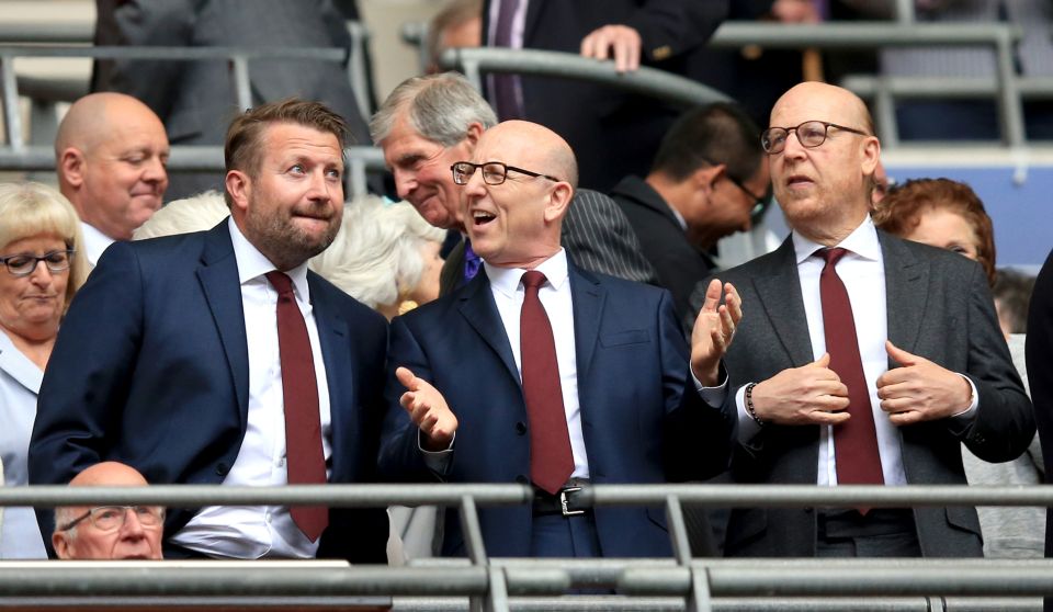 Joel Glazer, centre, and brother Avram, right, are co-chairman of Manchester United