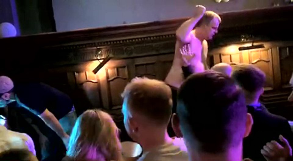 Coronation Street's Simon taking his top off and dancing on the table of a Manchester pub before being booted out