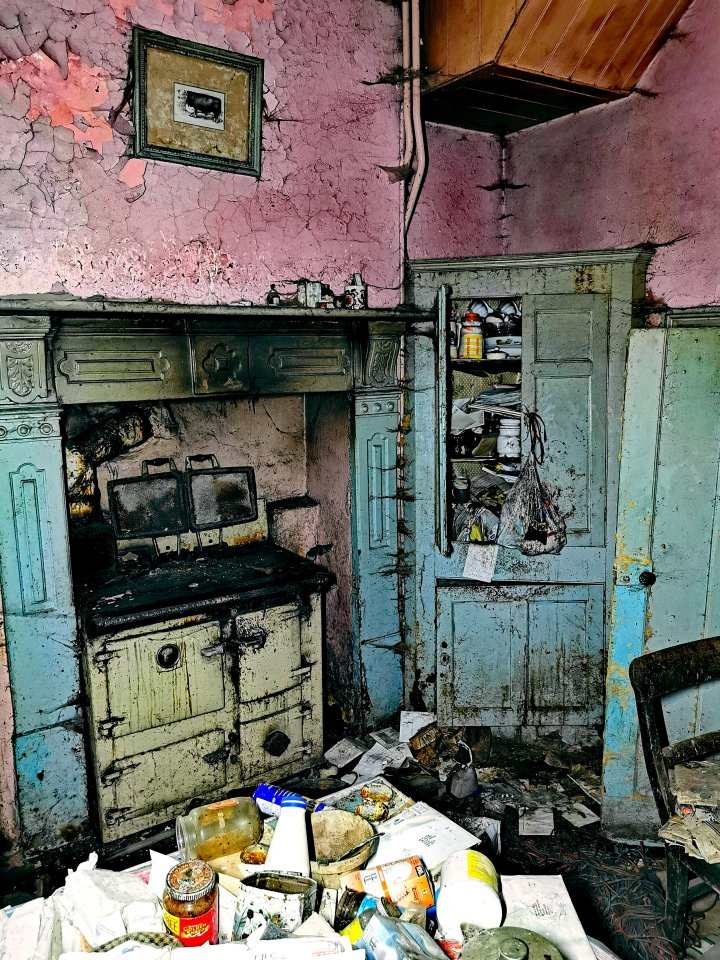 The kitchen is now covered in grime and littered with abandoned papers and containers