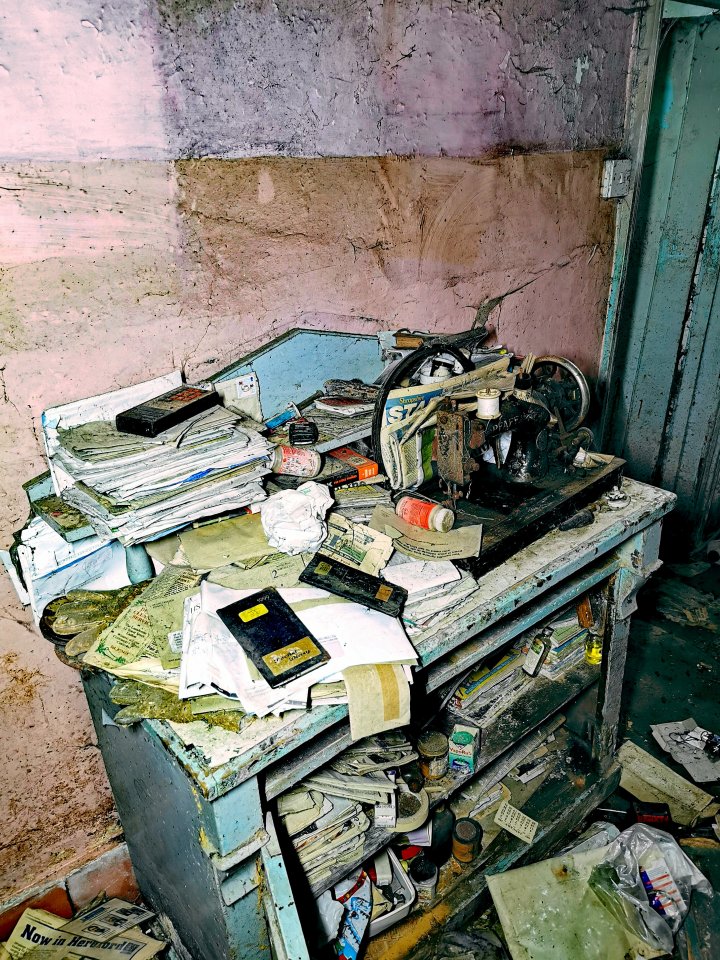 Piles of papers and an old sewing machine were just left littering the farmhouse