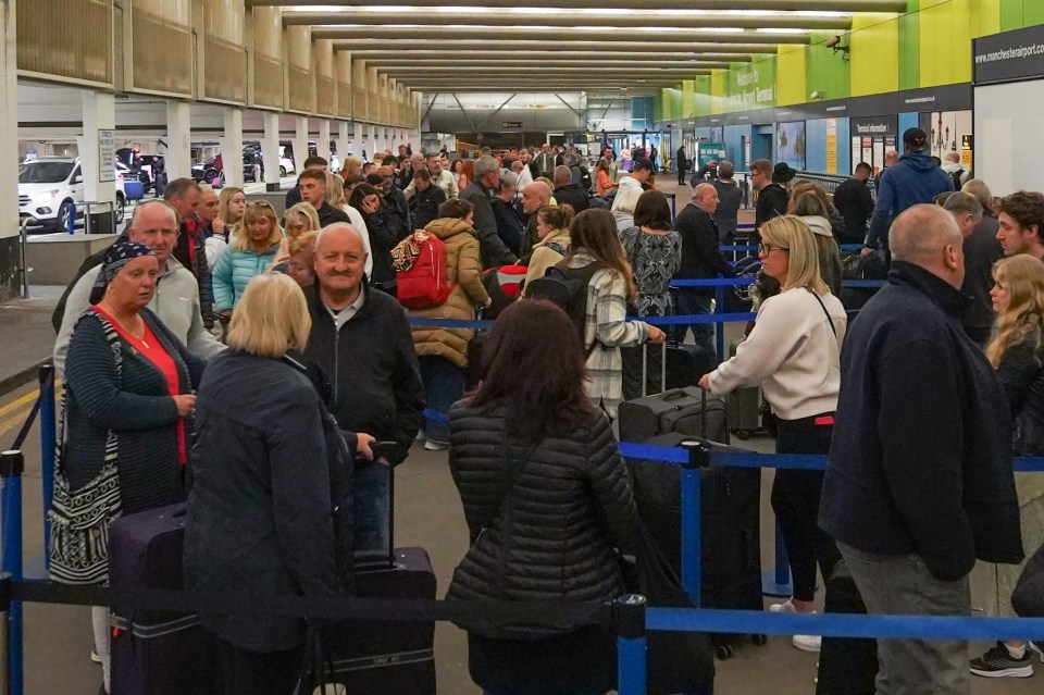 Passengers queueing at Manchester Airport on May Bank Holiday Monday