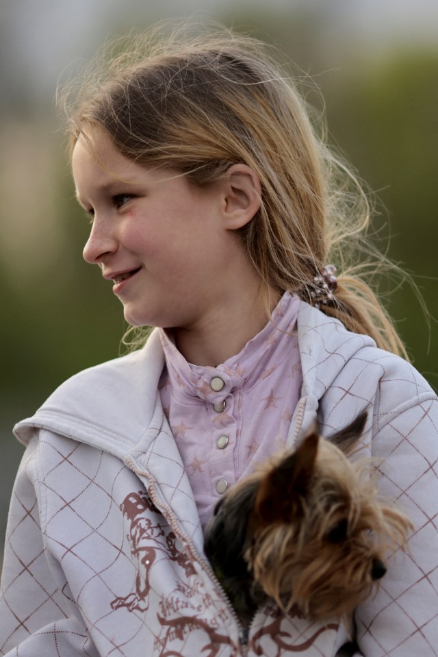 A refugee girl holds her dog after arriving in Zaporizhzhia