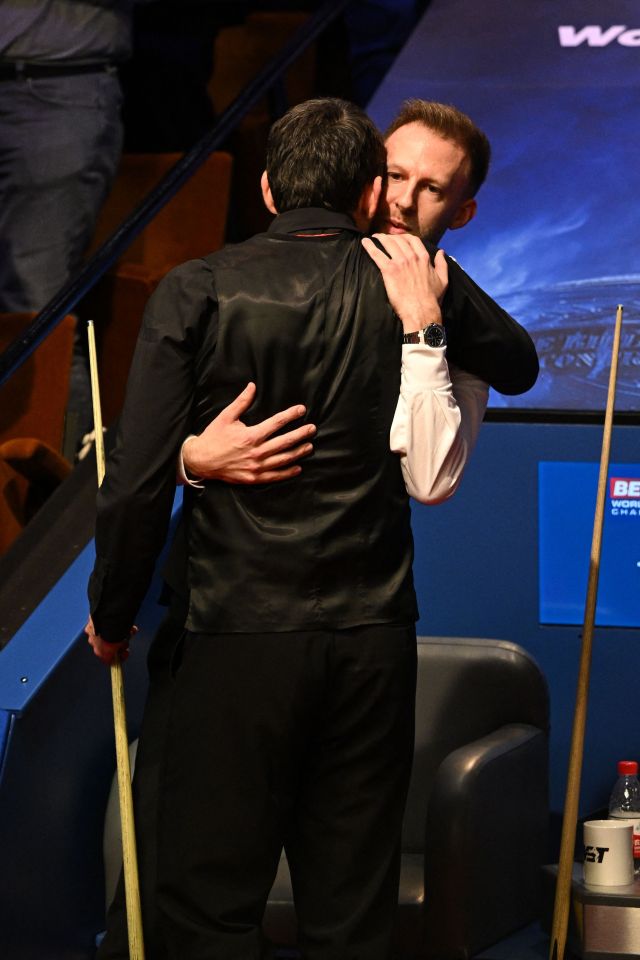 The star had an emotional embrace with Judd Trump after his win