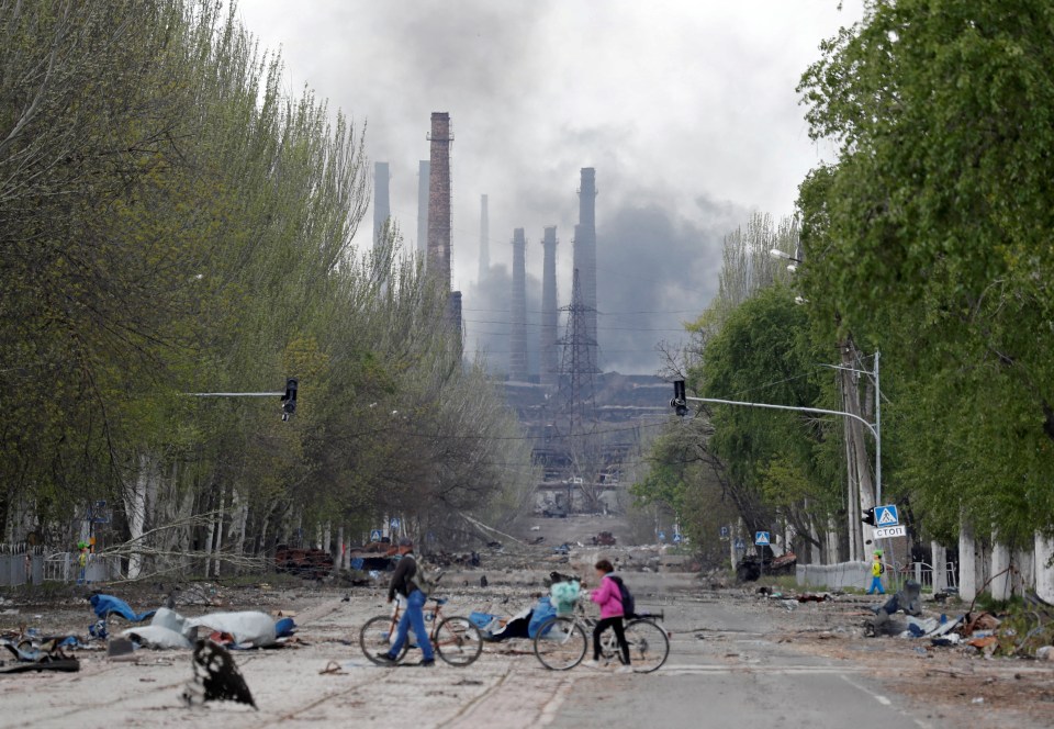 Russia launched a bid to storm the wrecked Azovstal steel plant – pictured a couple with bikes near the factory