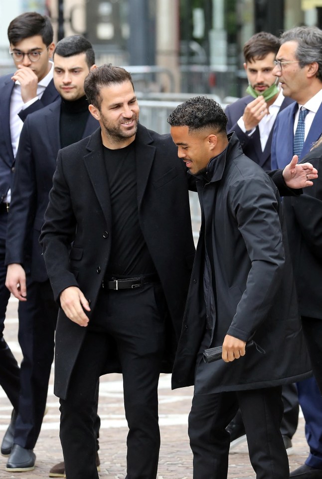 Justin Kluivert is greeted by Cesc Fabregas outside of the church