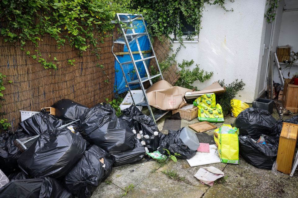 Bin bags, unwashed plates, food waste and other mess remains in the property