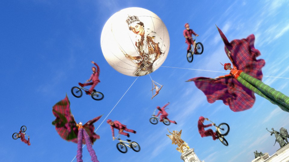 An aerial circus display underneath a balloon with the Queen’s image