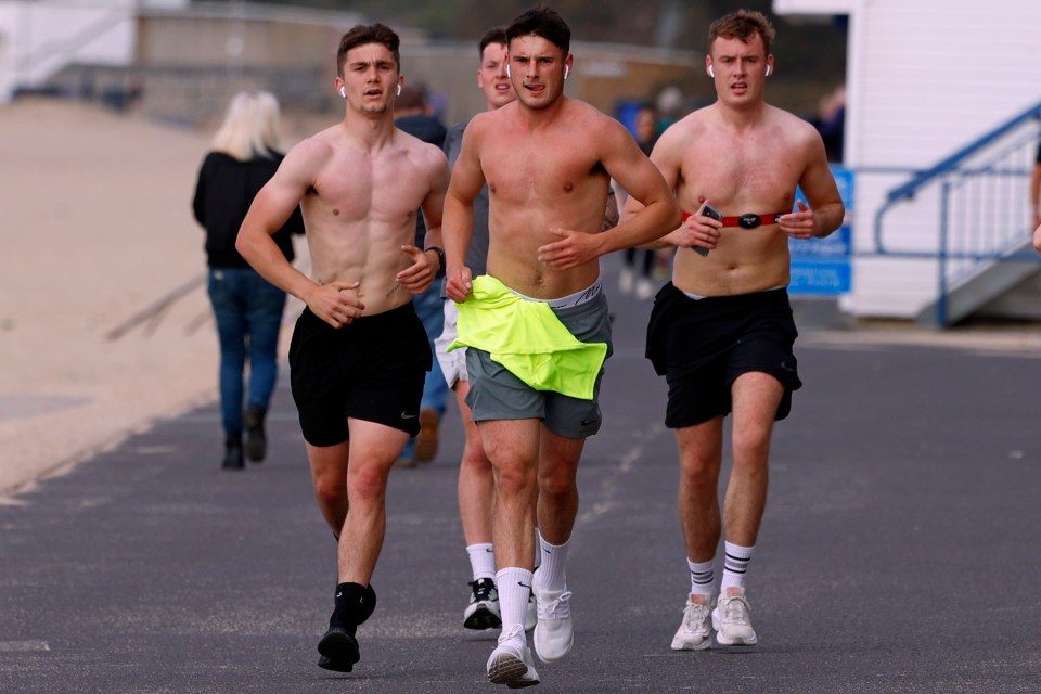 Three lads keep fit with a run at Branksome beach, Bournemouth