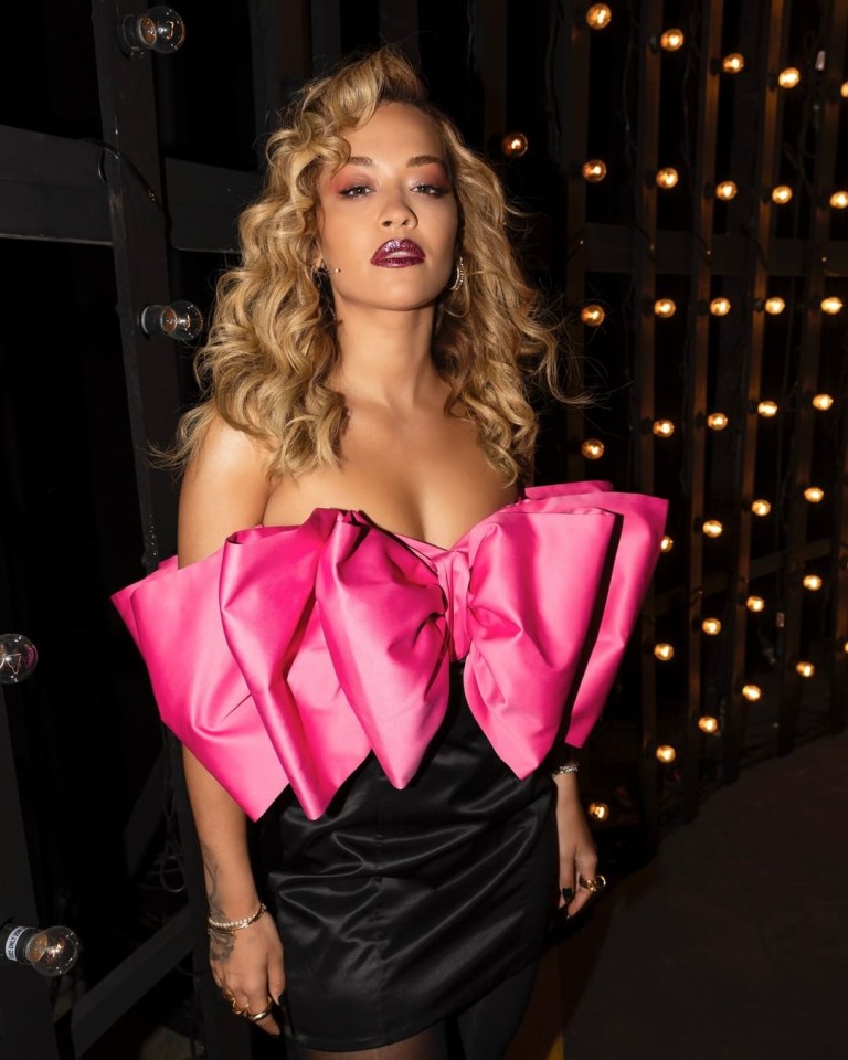 Rita Ora sported a giant pink bow on her chest as she posed backstage at The Voice Australia