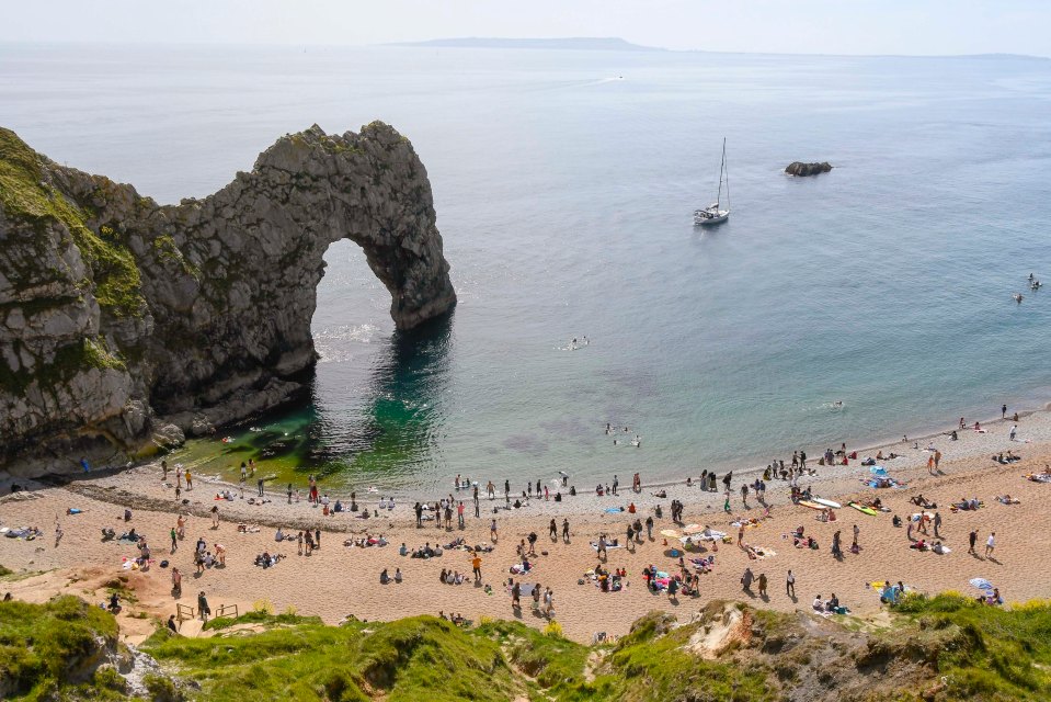 Beachgoers make the most of the fine weather at Durdle Door in Dorset