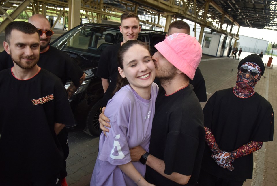 Oleg Psiuk gave his girlfriend a kiss as they crossed the border