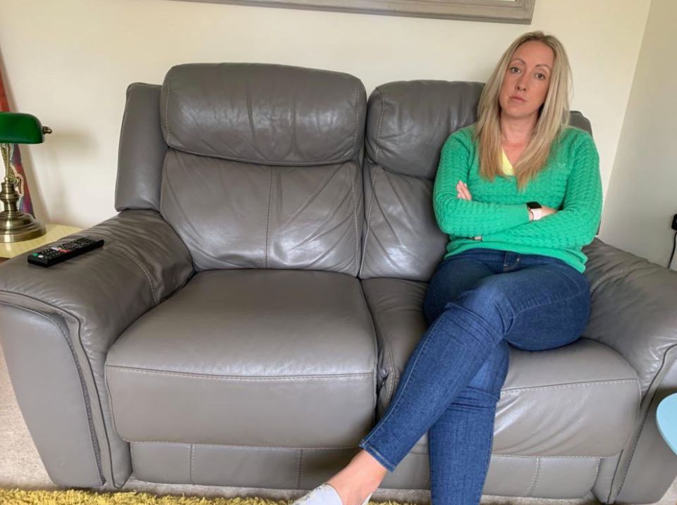 Jessica Glanfield pictured on the loan replacement sofa which she says 'stinks'