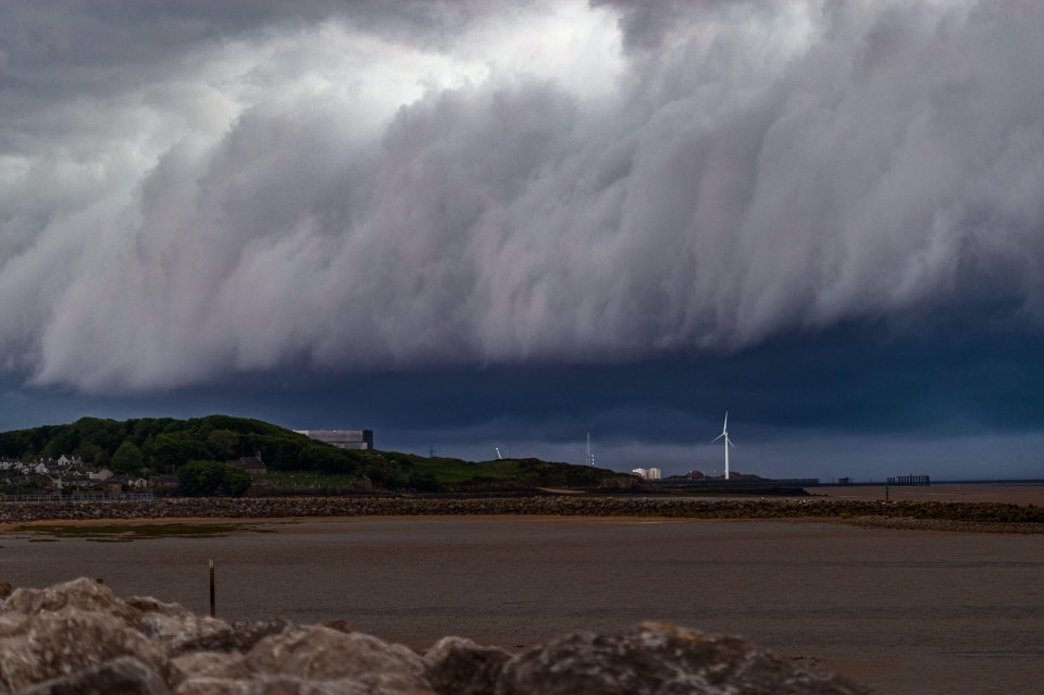 Millions of Brits were hit by rain last night - while this ominous-looking cloud over Morecambe Bay heralded a change in the weather