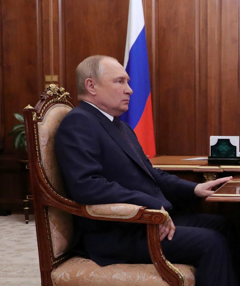 The Russian president gripped the table while seemingly struggling to breathe