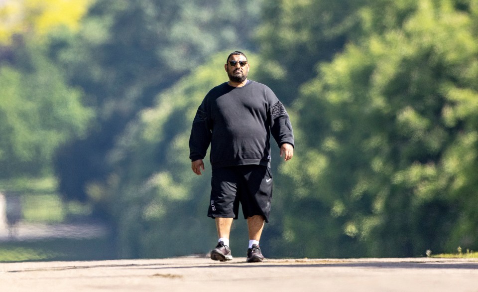 Prince Naseem Hamed looked unrecognisable on a dog walk after moving next to Queen in Windsor