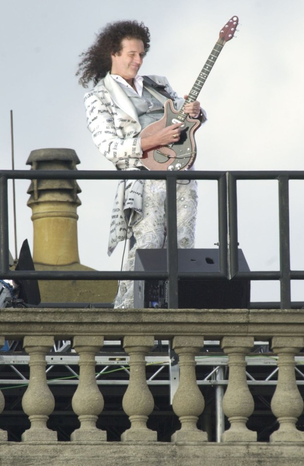 Brian May on the roof of Buckingham Palace for the Golden Jubilee in 2002