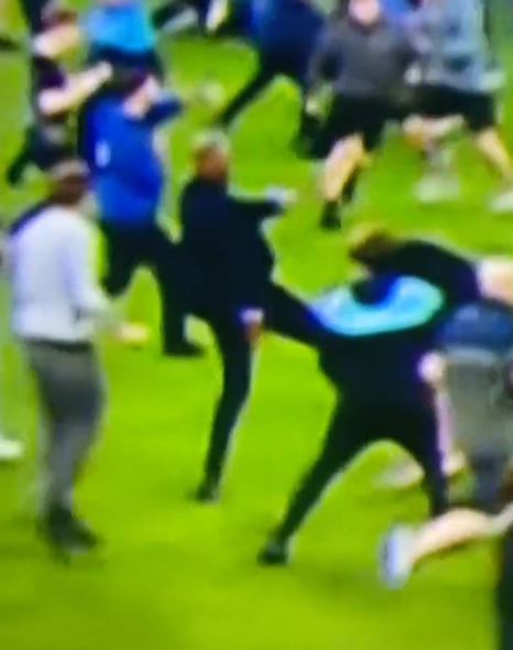 Patrick Vieira kicks out at an Everton pitch invader