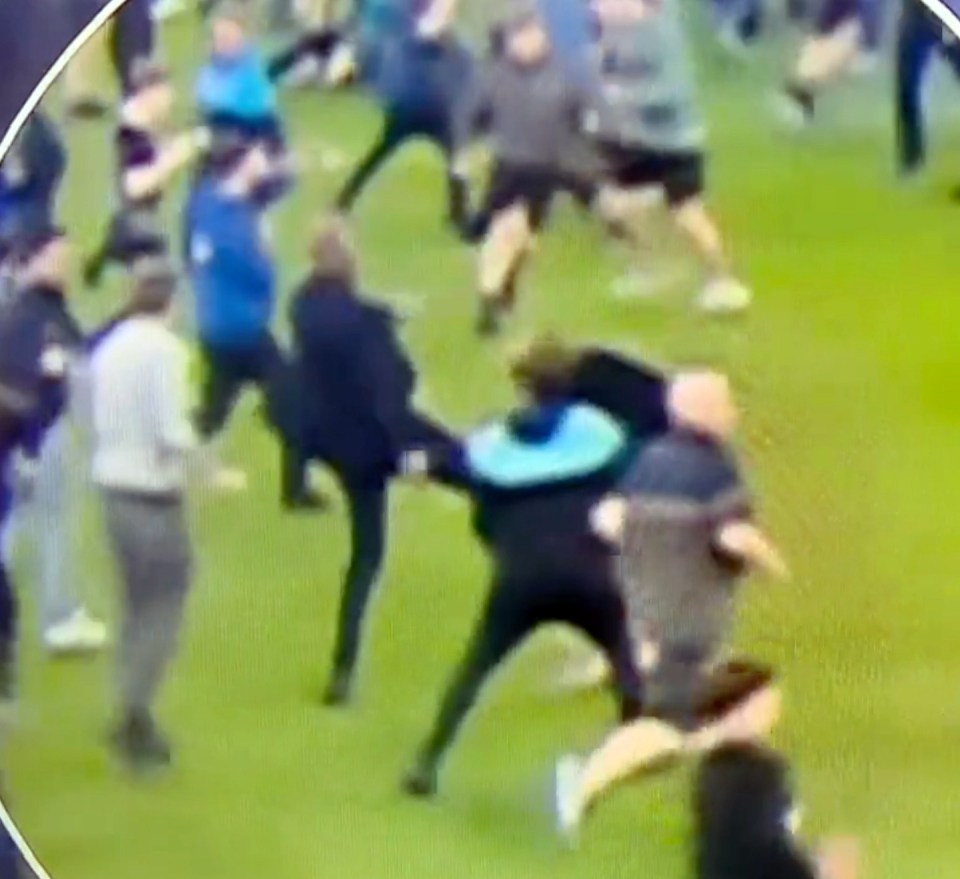 Patrick Vieira kicks out at an Everton fan after fans storm the pitch