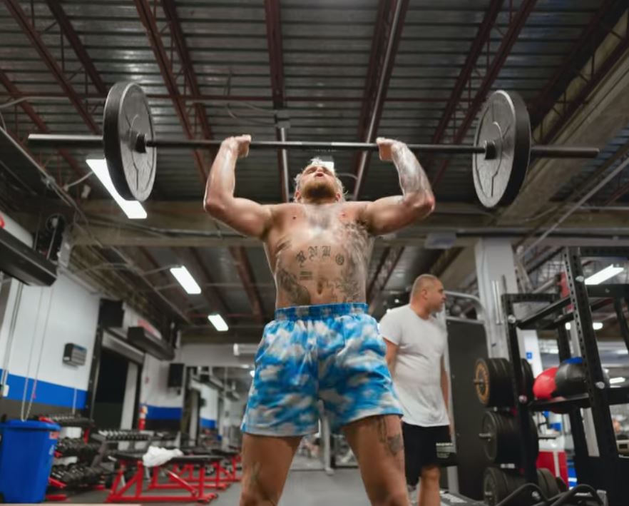 Jake Paul lifting weights in the gym