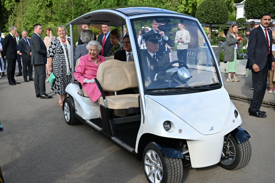 The Queen looked delighted as she was driven around the annual flower show in style