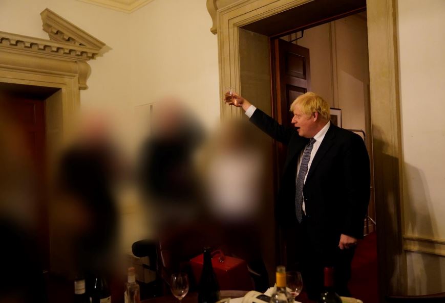 At another bash in November 2020, Mr Johnson was seen surrounded by open bottles of wine as he held aloft a tumbler