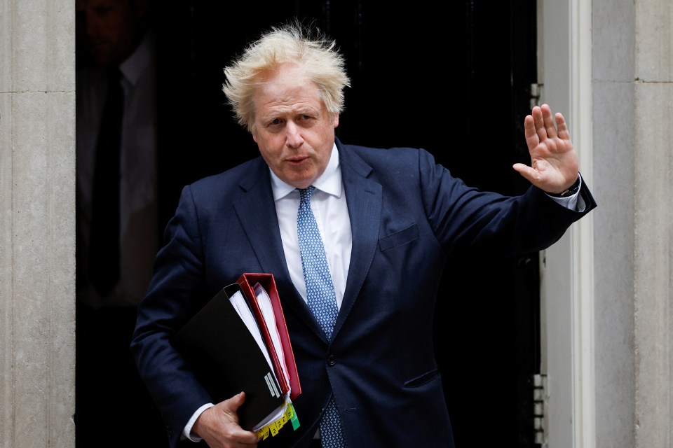 The embattled PM raised a hand to the press as he left Downing Street this morning