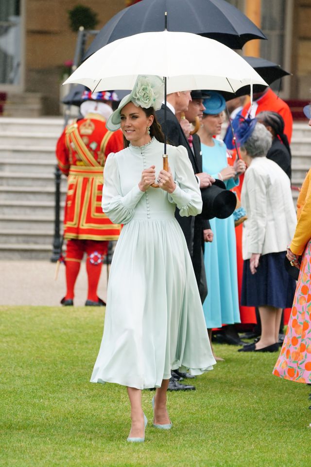 Kate wore an elegant mint green gown with matching fascinator and brolly