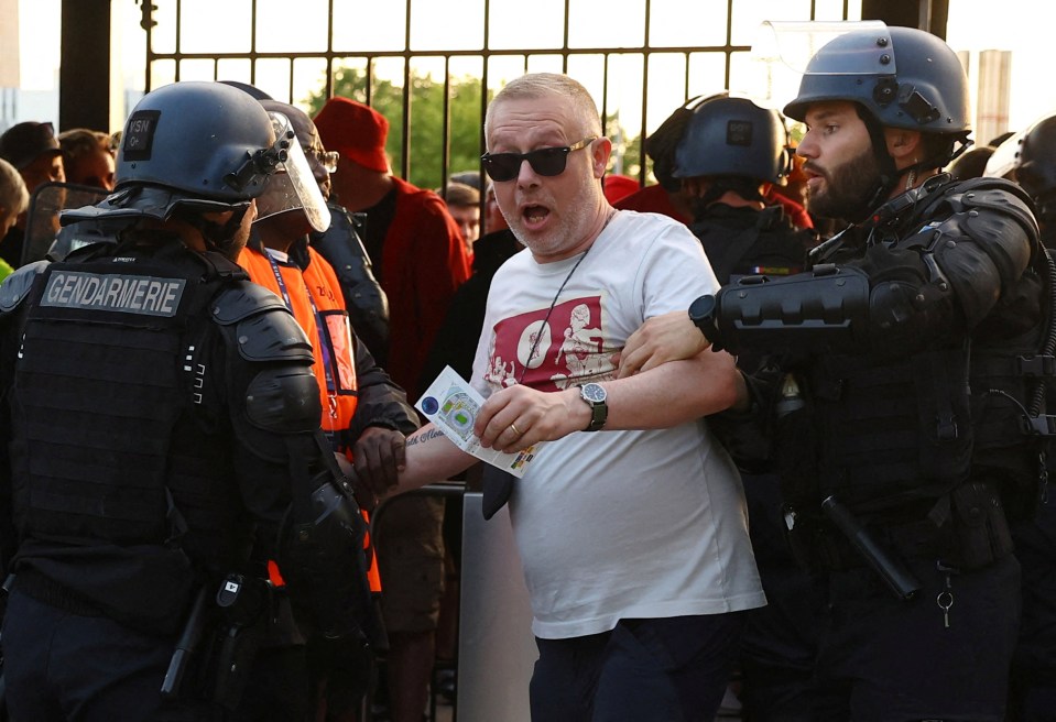 Heavy-handed French police grab a Liverpool fan