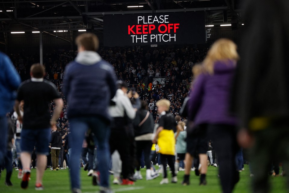 'Please keep off the pitch' was ignored as jubilant fans invaded the pitch