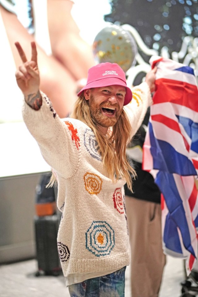 Sam arrived back in Heathrow waving a Union Jack