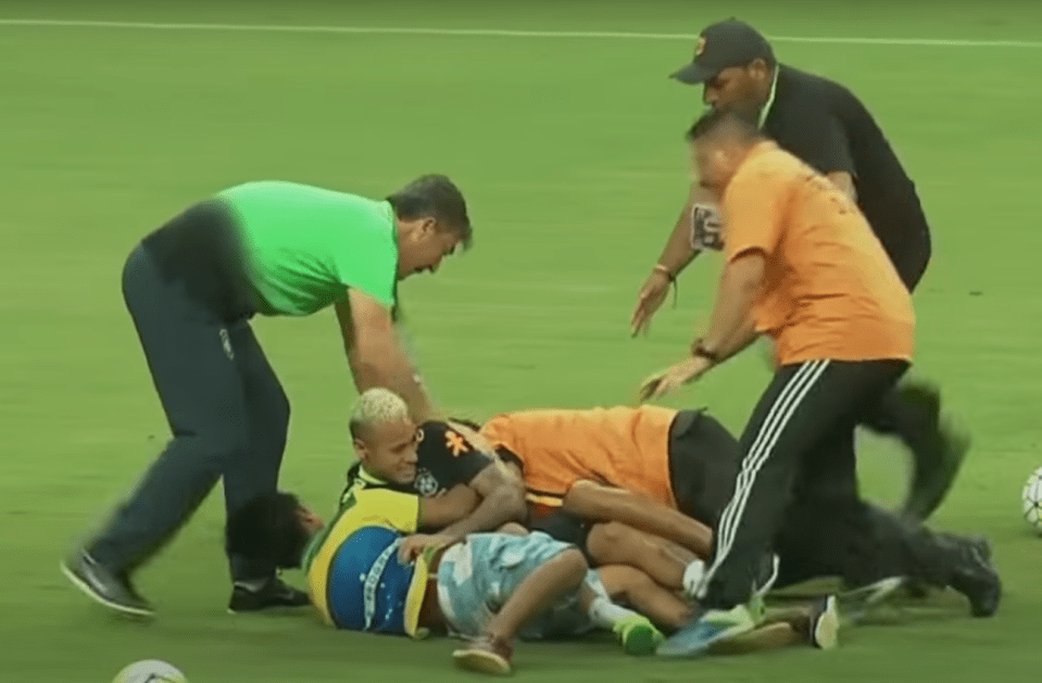 Brazil fans get carried away in a friendly nature as they bundle Neymar to the ground