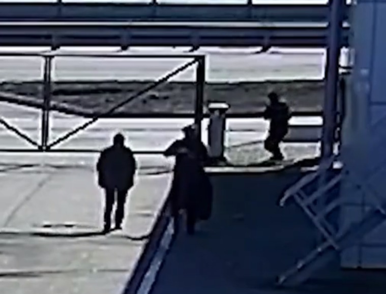 Two cowardly Russians sneak up to the fence before opening fire