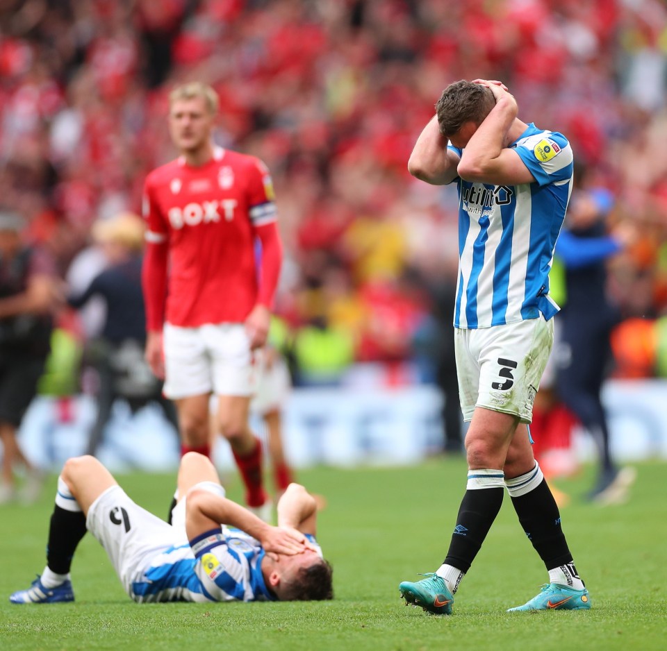 Dejected Huddersfield Town players react to defeat