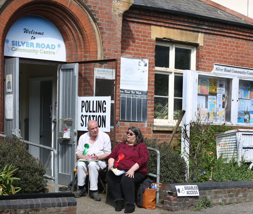 Party tellers from the Greens and Labour have a natter outside a polling station in Norwich