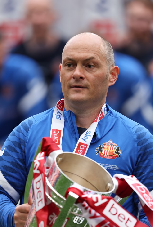 Alex Neil holds the play-off final trophy after getting his hands on it