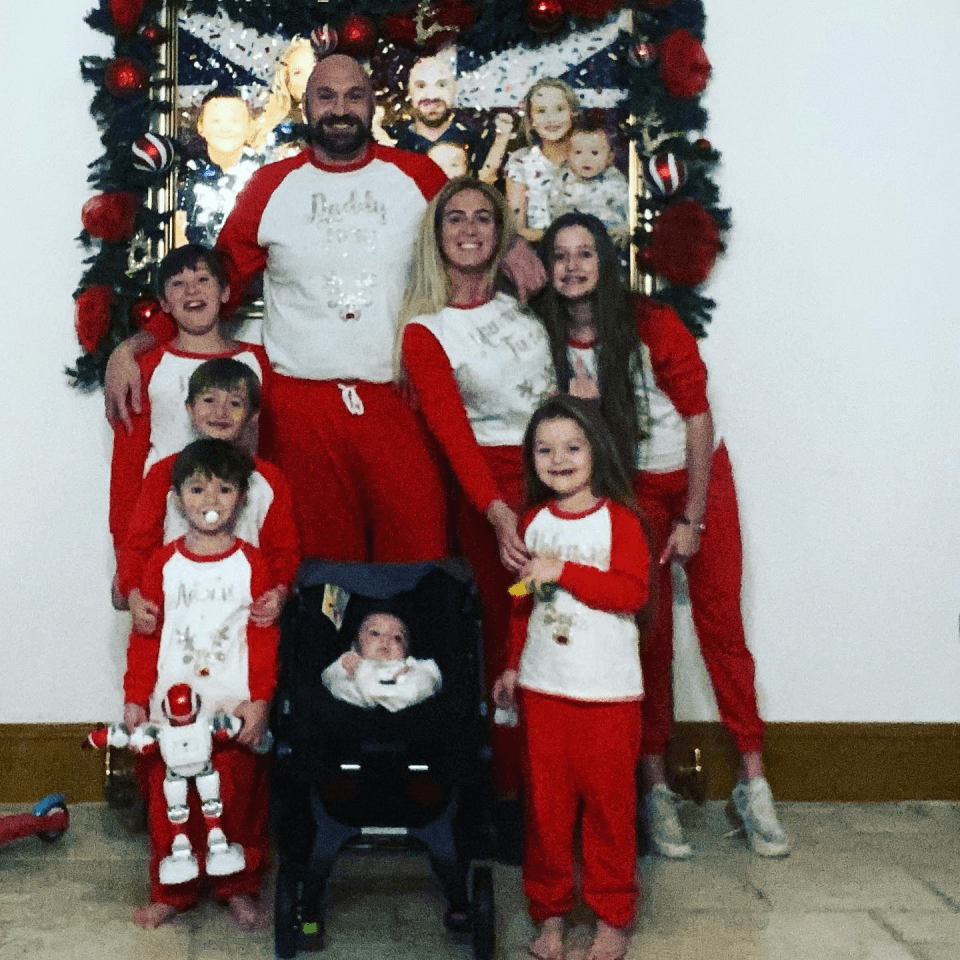 a family posing for a picture with a man wearing a shirt that says buddy