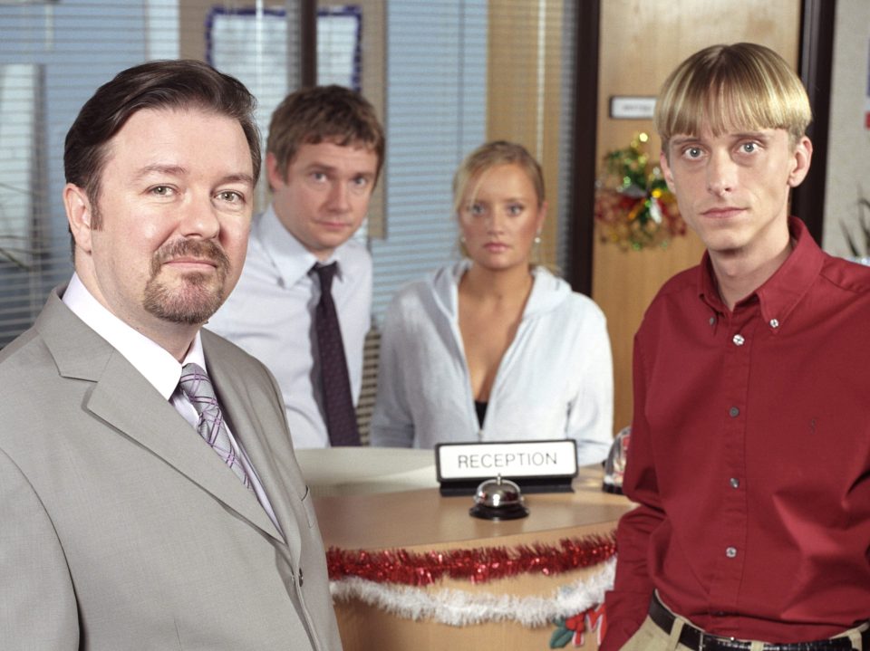 Ricky shot to telly fame with The Office where he played David Brent alongside Gareth Keenan (MACKENZIE CROOK) in foreground, Dawn (LUCY DAVIS) and Tim (MARTIN FREEMAN).