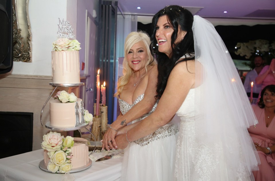 Sam and Linda beamed as they cut their three-tier wedding cake