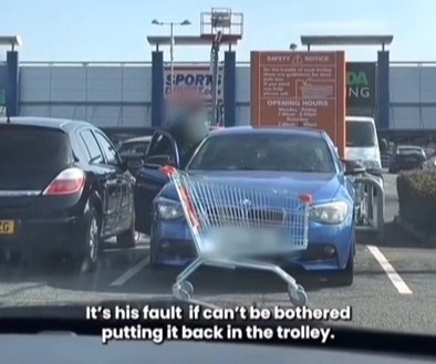 A lazy BMW driver was caught dumping a trolley into a parking space instead of putting it back