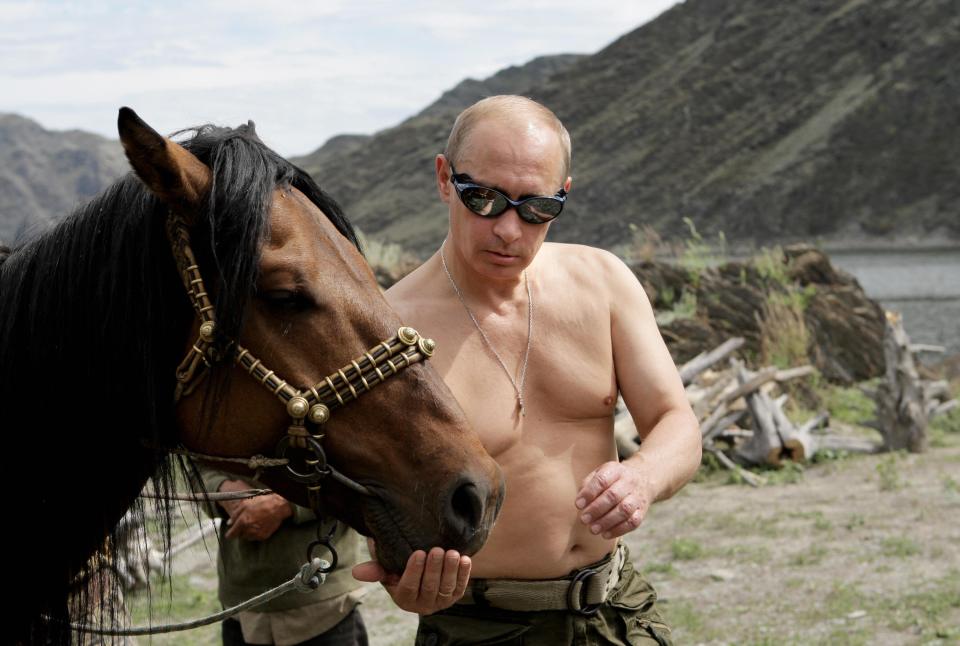 Russian Prime Minister Vladimir Putin pictured with a horse during his vacation in 2009