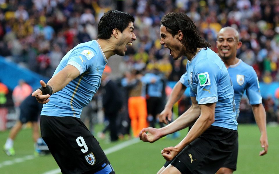 Suarez celebrates a goal with Cavani at the World Cup